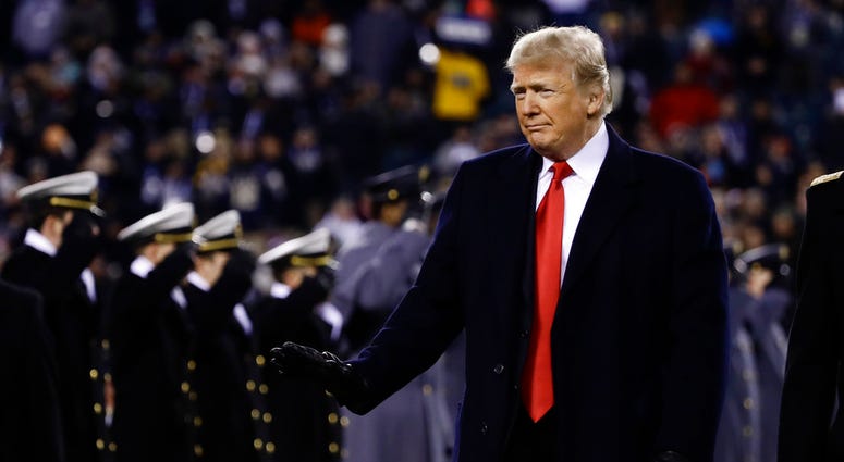 President Donald Trump crosses the field after the first half of an NCAA college football game between the Army and the Navy, Saturday, Dec. 8, 2018, in Philadelphia. President Donald Trump