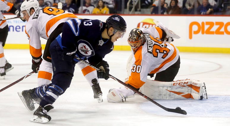 Winnipeg Jets' Brandon Tanev (13) scores against Philadelphia Flyers' goaltender Michal Neuvirth (30) after getting past Flyers' Ivan Provorov (9) during second-period NHL hockey game action in Winnipeg, Manitoba, Sunday, Dec. 9, 2018. Winnipeg Jets' Brandon Tanev (13) scores against Philadelphia Flyers' goaltender Michal Neuvirth (30) after getting past Flyers' Ivan Provorov (9) during second-period NHL hockey game action in Winnipeg, Manitoba, Sunday, Dec. 9, 2018.