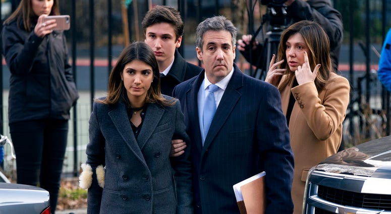 Michael Cohen, right, President Donald Trump's former lawyer, accompanied by his children and wife, arrive at federal court for his sentencing for dodging taxes, lying to Congress and violating campaign finance laws in New York on Dec. 12, 2018. Michael Cohen, right, President Donald Trump's former lawyer, accompanied by his children and wife, arrive at federal court for his sentencing for dodging taxes, lying to Congress and violating campaign finance laws in New York on Dec. 12, 2018.