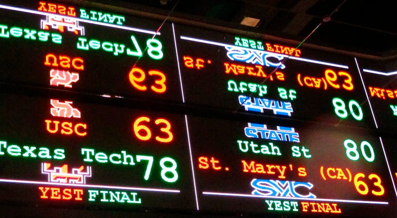 A scrolling video board with basketball scores reflected in the ceiling of the new sports book at Resorts Casino in Atlantic City, N.J. A scrolling video board with basketball scores
