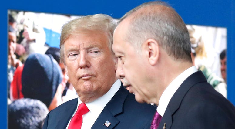 In this July 11, 2018 file photo, President Donald Trump, left, talks to Turkish President Recep Tayyip Erdogan as they tour the new NATO headquarters in Brussels, Belgium. President Donald Trump talks to Turkish President Recep Tayyip Erdogan.