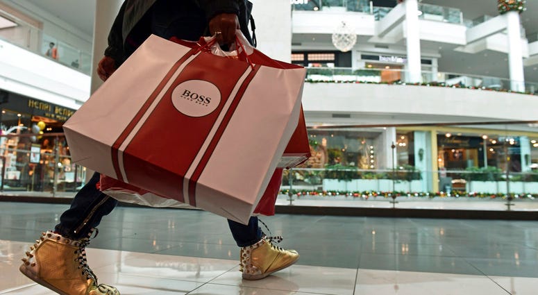In this Dec. 22, 2017, file photo, people shop at the Pentagon City Mall in Arlington, Va. In this Dec. 22, 2017, file photo, people shop at the Pentagon City Mall in Arlington, Va.