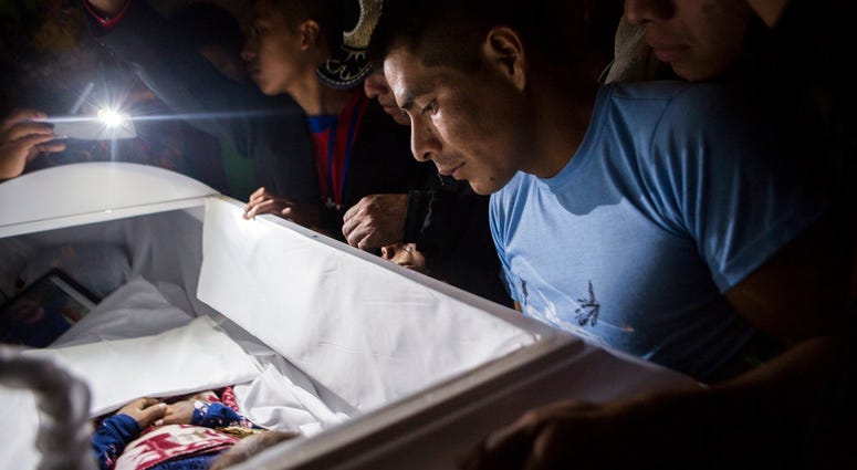 Family members pay their final respects to 7-year-old Jakelin Caal Maquin during a memorial service in her grandparent's home in San Antonio Secortez, Guatemala, Monday, Dec. 24, 2018. Family members pay their final respects to 7-year-old Jakelin Caal Maquin during a memorial service in her grandparent's home in San Antonio Secortez, Guatemala, Monday, Dec. 24, 2018.