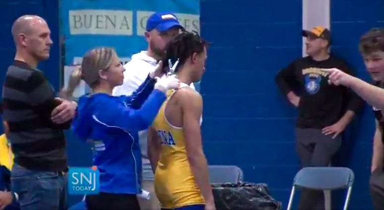 Buena Regional High School wrestler Andrew Johnson gets his dreadlocks cut off courtside minutes before his match in Buena, N.J., after a referee told Johnson he would forfeit his bout if he didn't get them cut; Dec. 19, 2018. Buena Regional High School wrestler Andrew Johnson gets his dreadlocks cut off courtside minutes before his match in Buena, N.J., after a referee told Johnson he would forfeit his bout if he didn't get them cut; Dec. 19, 2018.