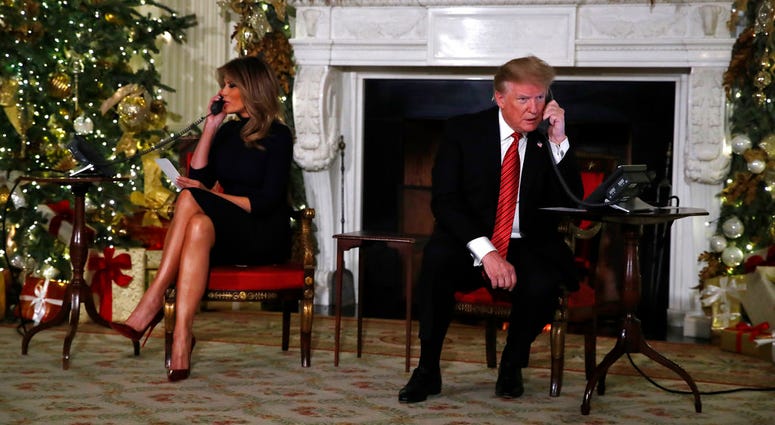 President Donald Trump and first lady Melania Trump each speak on the phone sharing updates to track Santa's movements from the North American Aerospace Defense Command (NORAD) Santa Tracker on Christmas Eve, Monday, Dec. 24, 2018. President Donald Trump and first lady Melania Trump
