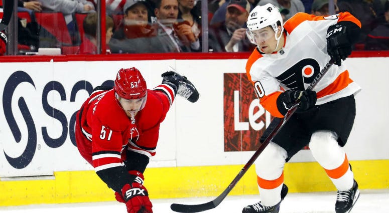 Carolina Hurricanes' Trevor van Riemsdyk (57) dives to tip the puck away from Philadelphia Flyers' Jordan Weal (40) during the second period of an NHL hockey game, Monday, Dec. 31, 2018, in Raleigh, N.C. Carolina Hurricanes' Trevor van Riemsdyk (57) dives to tip the puck away from Philadelphia Flyers' Jordan Weal (40) during the second period of an NHL hockey game, Monday, Dec. 31, 2018, in Raleigh, N.C.