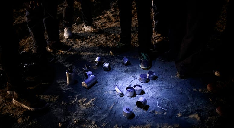Migrants stand by tear gas canisters they collected that were shot towards the Mexican side by U.S. Border Patrol officers after they attempted to get into the U.S. side to San Diego, Calif., from Tijuana, Mexico, Tuesday, Jan. 1, 2019. Migrants stand by tear gas canisters they collected that were shot towards the Mexican side by U.S. Border Patrol officers after they attempted to get into the U.S. side to San Diego, Calif., from Tijuana, Mexico, Tuesday, Jan. 1, 2019.