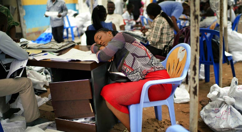 An exhausted Congolese independent electoral commission (CENI) official rests as results are tallied for the presidential election, at a local results compilation center in Kinshasa, Congo, Sunday, Jan. 6, 2019. An exhausted Congolese independent electoral commission (CENI) official rests as results are tallied for the presidential election, at a local results compilation center in Kinshasa, Congo, Sunday, Jan. 6, 2019.