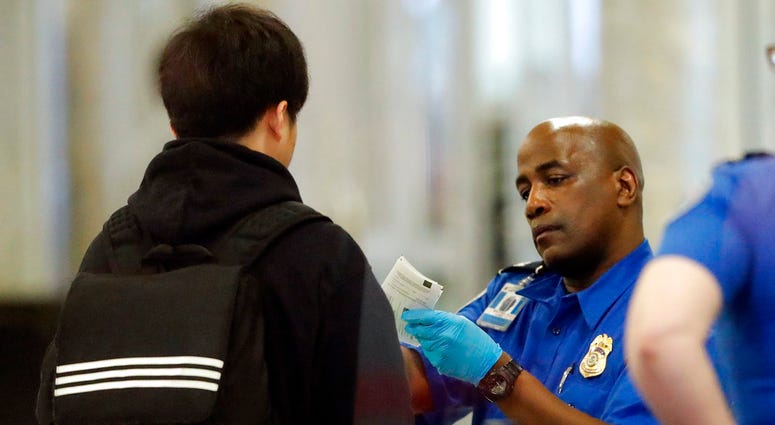 A Transportation Security Administration employee checks an air traveler's identification at Hartsfield Jackson Atlanta International Airport Monday, Jan. 7, 2019, in Atlanta. A Transportation Security Administration employee checks an air traveler's identification at Hartsfield Jackson Atlanta International Airport Monday, Jan. 7, 2019, in Atlanta.