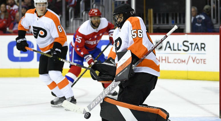 Philadelphia Flyers goaltender Mike McKenna (56) stops the puck during the second period of an NHL hockey game as Washington Capitals right wing Devante Smith-Pelly (25) watches, Tuesday, Jan. 8, 2019, in Washington. Philadelphia Flyers goaltender Mike McKenna (56) stops the puck during the second period of an NHL hockey game as Washington Capitals right wing Devante Smith-Pelly (25) watches, Tuesday, Jan. 8, 2019, in Washington.