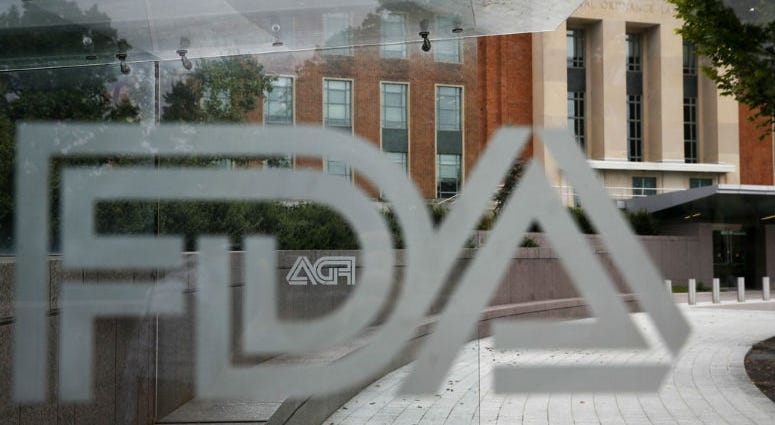 This Aug. 2, 2018, file photo shows the U.S. Food and Drug Administration building behind FDA logos at a bus stop on the agency's campus in Silver Spring, Md. This Aug. 2, 2018, file photo shows the U.S. Food and Drug Administration building behind FDA logos at a bus stop on the agency's campus in Silver Spring, Md.