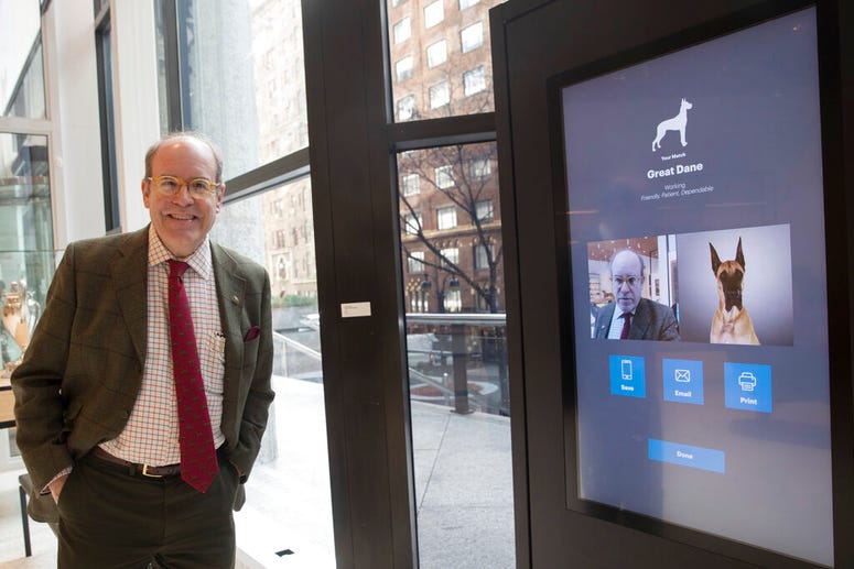This Wednesday, Jan. 9, 2019, photo shows American Kennel Club Museum of the Dog's Executive Director Alan Fausel smiling after finding his dog breed match at the Find Your Match interactive kiosk during a tour of the museum in New York. American Kennel Club Museum of the Dog's Executive Director Alan Fausel smiling after finding his dog breed match at the Find Your Match interactive kiosk.