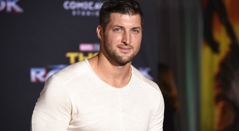 FILE - In this Tuesday, Oct. 10, 2017 file photo, Tim Tebow arrives at the world premiere of "Thor: Ragnarok" at the El Capitan Theatre in Los Angeles. FILE - In this Tuesday, Oct. 10, 2017 file photo, Tim Tebow arrives at the world premiere of "Thor: Ragnarok" at the El Capitan Theatre in Los Angeles.