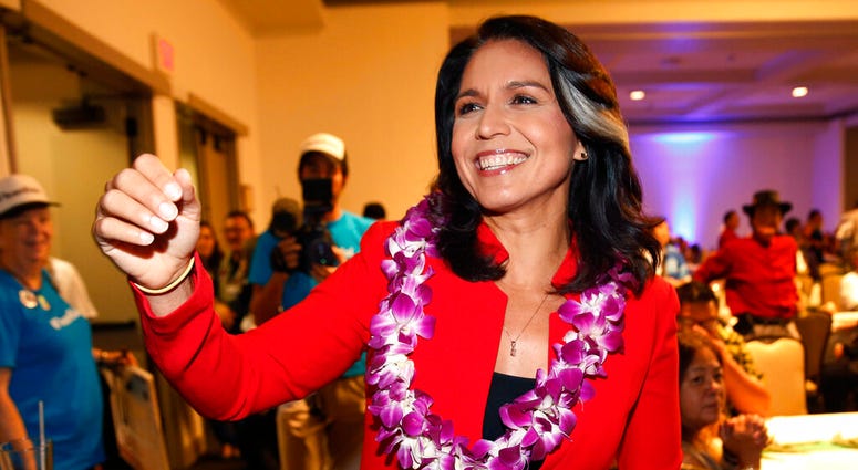 In this Nov. 6, 2018, file photo, Rep. Tulsi Gabbard, D-Hawaii, greets supporters in Honolulu. Tulsi Gabbard
