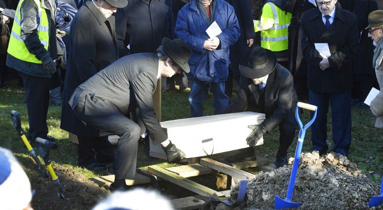 A coffin with the remains of six unidentified Holocaust victims is buried at the United Synagogue's New Cemetery in Bushey, England, Sunday Jan. 20, 2019. A coffin with the remains of six unidentified Holocaust victims is buried at the United Synagogue's New Cemetery in Bushey, England, Sunday Jan. 20, 2019.