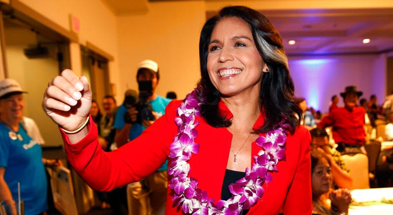 In this Nov. 6, 2018, file photo, Rep. Tulsi Gabbard, D-Hawaii, greets supporters in Honolulu. In this Nov. 6, 2018, file photo, Rep. Tulsi Gabbard, D-Hawaii, greets supporters in Honolulu.