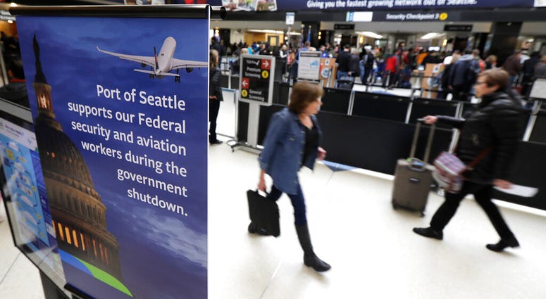 A sign near a TSA security checkpoint states the Port of Seattle's support for federal government workers, Friday, Jan. 25, 2019, in Seattle. A sign near a TSA security checkpoint states the Port of Seattle's support for federal government workers, Friday, Jan. 25, 2019, in Seattle.