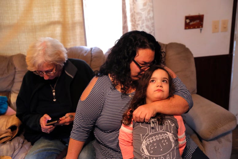 Tina Chastant hugs her daughter Rosalina Chastant, 5, in Gonzalez, La., Sunday, Jan. 27, 2019, after they arrived to comfort Kim Mincks, left, after two people were found dead inside the home yesterday. Tina Chastant hugs her daughter Rosalina Chastant, 5, in Gonzalez, La., Sunday, Jan. 27, 2019, after they arrived to comfort Kim Mincks, left, after two people were found dead inside the home yesterday.