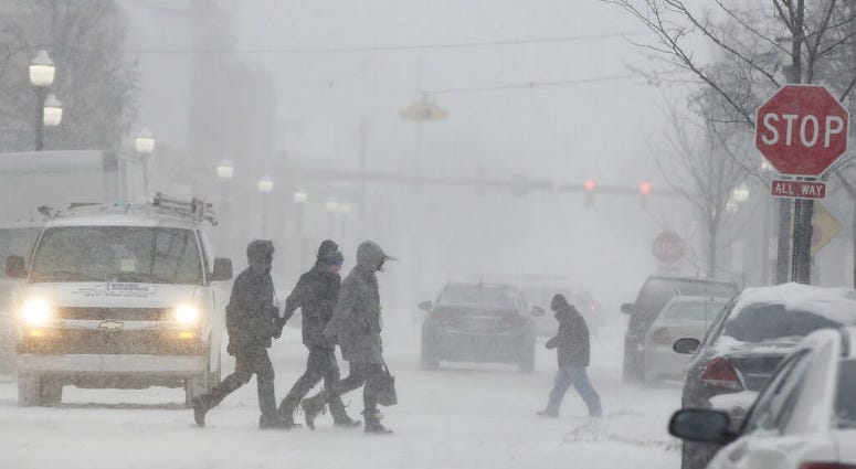 People walk through a snowstorm in downtown Jackson, Mich., Monday, Jan. 28, 2019. People walk through a snowstorm in downtown Jackson, Mich., Monday, Jan. 28, 2019.