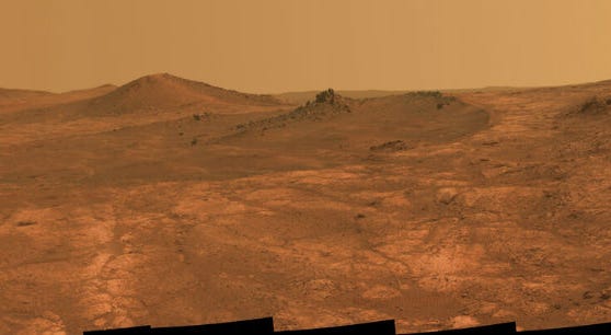 FILE - This composite of March 2015 photos made available by NASA shows a shallow crater called Spirit of St. Louis, about 110 feet (34 meters) long and about 80 feet (24 meters) wide, with a floor slightly darker than surrounding terrain. FILE - This composite of March 2015 photos made available by NASA shows a shallow crater called Spirit of St. Louis, about 110 feet (34 meters) long and about 80 feet (24 meters) wide, with a floor slightly darker than surrounding terrain.
