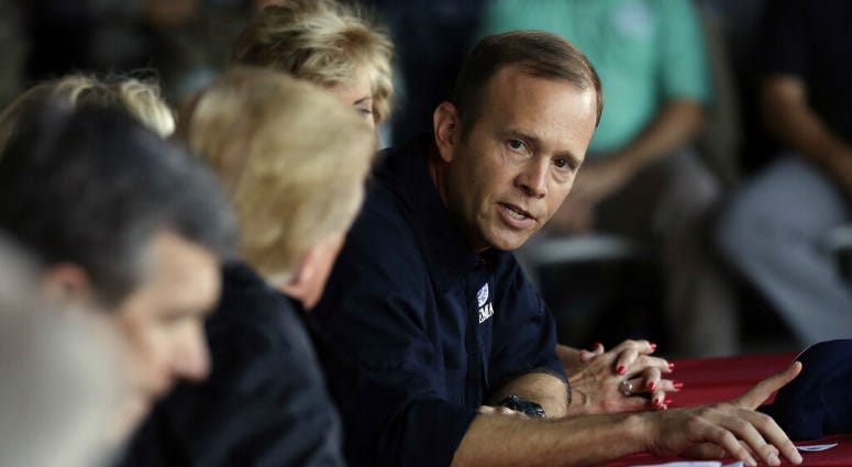 FILE - In this Sept. 19, 2018, file photo, President Donald Trump listens as FEMA Administrator Brock Long, right, speaks while attending a briefing, after arriving at Marine Corps Air Station Cherry Point to visit areas impacted by Hurricane Florence in FILE - In this Sept. 19, 2018, file photo, President Donald Trump listens as FEMA Administrator Brock Long, right, speaks while attending a briefing, after arriving at Marine Corps Air Station Cherry Point to visit areas impacted by Hurricane Florence in