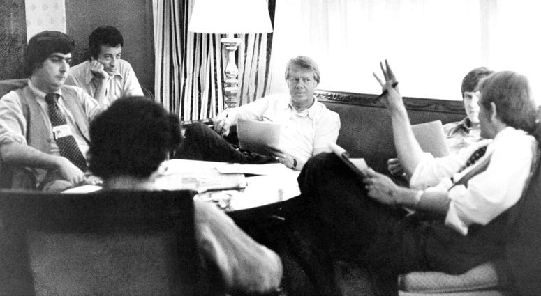 In this Tuesday, July 14, 1976 file photo, Jimmy Carter, center, meets with his staff, from back left, Pat Caddell, Jerry Rafshoon, his son, Chip and Jody Powell, and front left, Pat Anderson, at the Americana Hotel in New York. In this Tuesday, July 14, 1976 file photo, Jimmy Carter, center, meets with his staff, from back left, Pat Caddell, Jerry Rafshoon, his son, Chip and Jody Powell, and front left, Pat Anderson, at the Americana Hotel in New York.