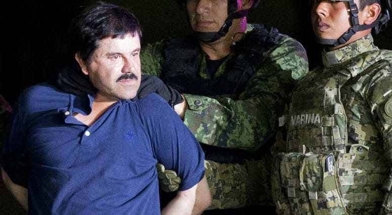 FILE - In this Jan. 8, 2016 file photo, a handcuffed Joaquin "El Chapo" Guzman is made to face the press as he is escorted to a helicopter by Mexican soldiers and marines at a federal hangar in Mexico City. FILE - In this Jan. 8, 2016 file photo, a handcuffed Joaquin "El Chapo" Guzman is made to face the press as he is escorted to a helicopter by Mexican soldiers and marines at a federal hangar in Mexico City.