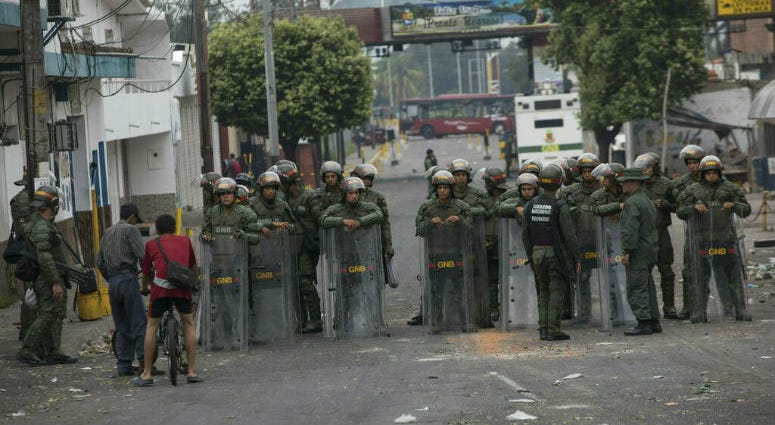 Bolivarian National Guards stand in the street in Urena, Venezuela, as part of Venezuela's closure of the border bridge to Colombia, Sunday, Feb. 24, 2019. Bolivarian National Guards stand in the street in Urena, Venezuela, as part of Venezuela's closure of the border bridge to Colombia, Sunday, Feb. 24, 2019.