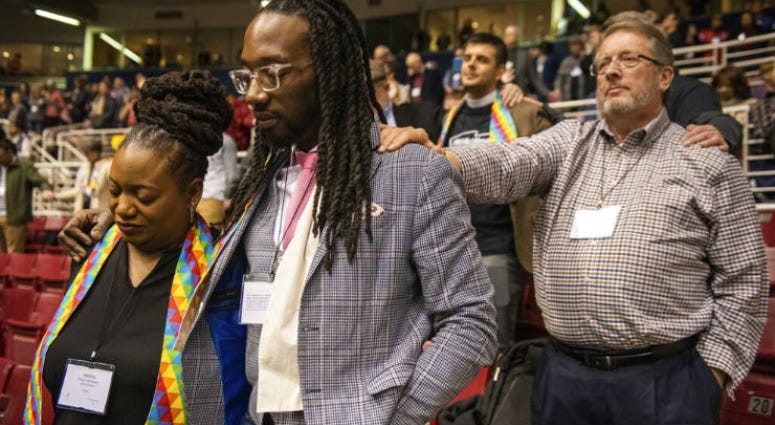 Adama Brown-Hathasway, left, The Rev. Dr. Jay Williams, both from Boston, and Ric Holladay of Kentucky join in prayer during the 2019 Special Session of the General Conference of The United Methodist Church in St. Louis, Mo., Tuesday, Feb. 26, 2019. Adama Brown-Hathasway, left, The Rev. Dr. Jay Williams, both from Boston, and Ric Holladay of Kentucky join in prayer during the 2019 Special Session of the General Conference of The United Methodist Church in St. Louis, Mo., Tuesday, Feb. 26, 2019.