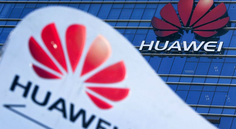 FILE - This Dec. 18, 2018, file photo, shows company signage on display near the Huawei office building at its research and development center in Dongguan, in south China's Guangdong province. FILE - This Dec. 18, 2018, file photo, shows company signage on display near the Huawei office building at its research and development center in Dongguan, in south China's Guangdong province.