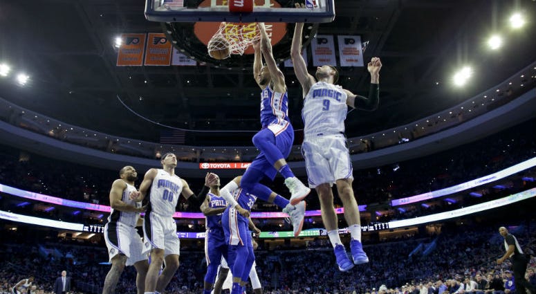 Philadelphia 76ers' Ben Simmons, center, dunks the ball past Orlando Magic's Nikola Vucevic, right, during the first half of an NBA basketball game, Tuesday, March 5, 2019, in Philadelphia. Philadelphia 76ers' Ben Simmons, center, dunks the ball past Orlando Magic's Nikola Vucevic, right, during the first half of an NBA basketball game, Tuesday, March 5, 2019, in Philadelphia.