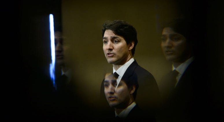 FILE - In this March 8, 2019, file photo, Prime Minister Justin Trudeau is seen through a beveled pane of glass in a door as he takes part in a news conference in Iqaluit, Nunavut, Canada. FILE - In this March 8, 2019, file photo, Prime Minister Justin Trudeau is seen through a beveled pane of glass in a door as he takes part in a news conference in Iqaluit, Nunavut, Canada.