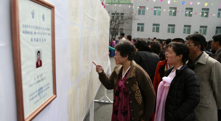 People inspect the list of voters as portrait of a candidate for the national legislature is displayed on the left, during the election at a polling station in Pyongyang, North Korea, Sunday, March 10, 2019. People inspect the list of voters as portrait of a candidate for the national legislature is displayed on the left, during the election at a polling station in Pyongyang, North Korea, Sunday, March 10, 2019.