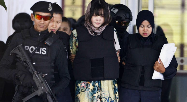 FILE - In this April 5, 2018, file photo, Vietnamese Doan Thi Huong, center, is escorted by police as she leaves after a court hearing at the Shah Alam High Court in Shah Alam, Malaysia. FILE - In this April 5, 2018, file photo, Vietnamese Doan Thi Huong, center, is escorted by police as she leaves after a court hearing at the Shah Alam High Court in Shah Alam, Malaysia.
