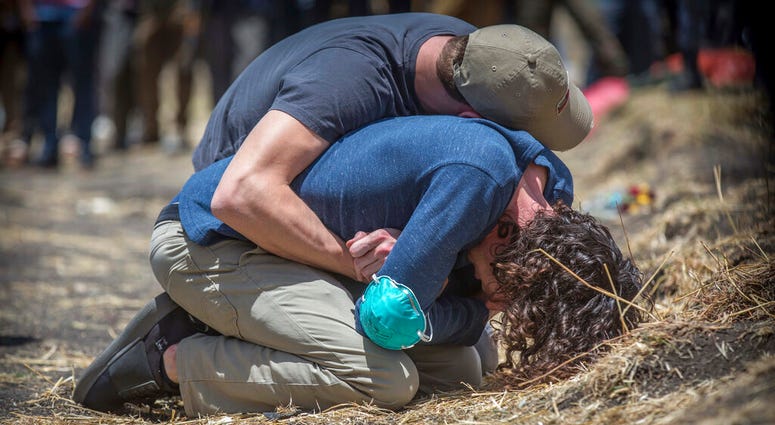 Relatives react at the scene where the Ethiopian Airlines Boeing 737 Max 8 crashed shortly after takeoff on Sunday killing all 157 on board, near Bishoftu, south of Addis Ababa, in Ethiopia Wednesday, March 13, 2019. Relatives react at the scene where the Ethiopian Airlines Boeing 737 Max 8 crashed.