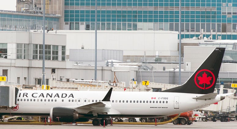 An Air Canada Boeing 737 Max 8 aircraft is parked next to a gate at Trudeau Airport in Montreal, Wednesday, March 13, 2019. An Air Canada Boeing 737 Max 8 aircraft