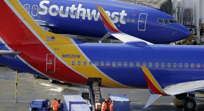 FILE - In this Feb. 5, 2019, file photo, Southwest Airlines planes are loaded at Seattle-Tacoma International Airport in Seattle. Southwest Airlines planes are loaded at Seattle-Tacoma International Airport in Seattle.