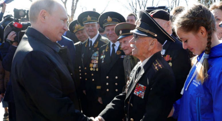 Russian President Vladimir Putin, right, meets with local residents and veterans at the historical memorial the Malakhov Kurgan (Malakoff redoubt) in Sevastopol, Crimea, Monday, March 18, 2019. Russian President Vladimir Putin, right, meets with local residents and veterans at the historical memorial the Malakhov Kurgan (Malakoff redoubt) in Sevastopol, Crimea, Monday, March 18, 2019.