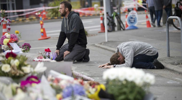 Mourners pray near the Linwood mosque in Christchurch, New Zealand, Tuesday, March 19, 2019. Mourners pray near the Linwood mosque in Christchurch, New Zealand.