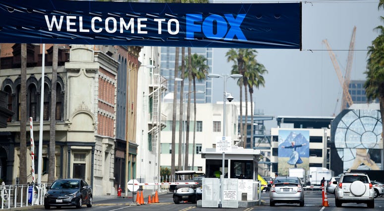 Cars enter and leave Fox Studios, Tuesday, March 19, 2019, in Los Angeles. Cars enter and leave Fox Studios.