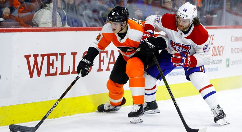 Philadelphia Flyers' Travis Sanheim, left, and Montreal Canadiens' Jonathan Drouin battle for the puck during the first period of an NHL hockey game, Tuesday, March 19, 2019, in Philadelphia. ( Philadelphia Flyers' Travis Sanheim, left, and Montreal Canadiens' Jonathan Drouin battle for the puck during the first period of an NHL hockey game.