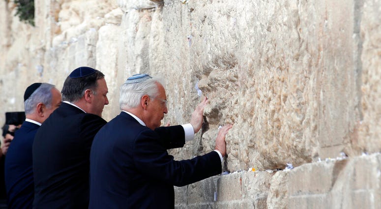 Israeli Prime Minister Benjamin Netanyahu, U.S. Secretary of State Mike Pompeo and U.S. Ambassador to Israel David Friedman touch the stones of the Western Wall during a visit to the site in Jerusalem's Old City, Thursday, March 21, 2019. Israeli Prime Minister Benjamin Netanyahu, U.S. Secretary of State Mike Pompeo and U.S. Ambassador to Israel David Friedman