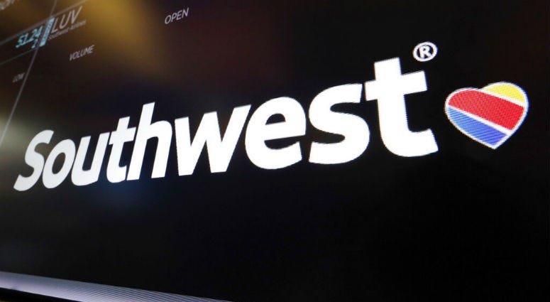 FILE - In this Monday, March 18, 2019, file photo, the logo for Southwest Airlines appears above a trading post on the floor of the New York Stock Exchange. The Federal Aviation Administration says a Southwest Airlines Boeing 737 Max jet made a safe emergency landing Tuesday, March 26, 2019, in Orlando, Fla., after experiencing an apparent engine problem.