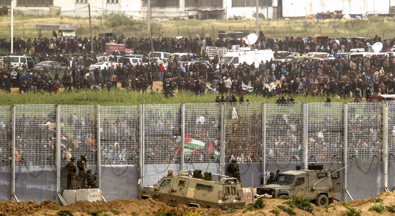 Israeli soldiers take positions on the Israel and Gaza border during a Palestinian protest, Saturday, March 30, 2019. Tens of thousands of Palestinians have rallied at points near the Israeli border to mark the first anniversary of weekly protests in the Gaza Strip.
