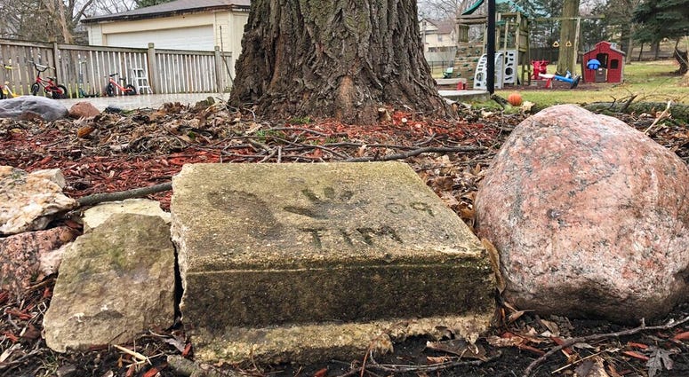 A slab of concrete sits in the backyard of the house where Timmothy Pitzen used to live in Aurora, Illinois, Thursday, April, 2019. Authorities conducted DNA testing to try to determine Thursday whether a teenager found wandering the streets of a Kentucky town is who he claims to be — an Illinois boy who disappeared eight years ago around the time his mother took her own life.
