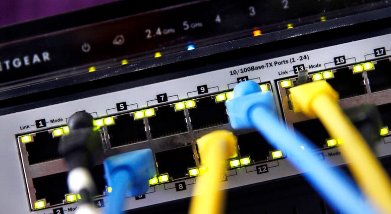 In this June 19, 2018, file photo a router and internet switch are displayed in East Derry, N.H. A router and internet switch