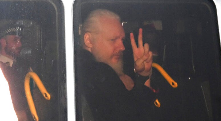 Julian Assange gestures as he arrives at Westminster Magistrates' Court in London, after the WikiLeaks founder was arrested by officers from the Metropolitan Police and taken into custody, April 11, 2019. Julian Assange
