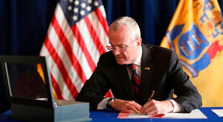 Gov. Phil Murphy signs the Medical Aid in Dying for the Terminally Ill Act Friday, April 12, 2019 at the New Jersey Statehouse in Trenton, N.J. Gov. Phil Murphy