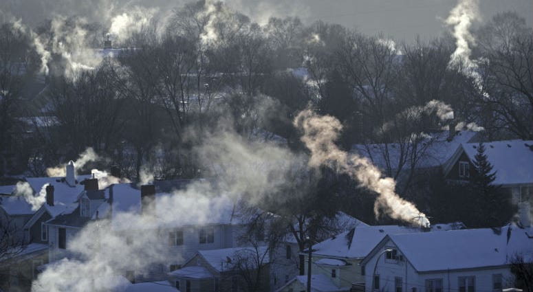 FILE- In this Wednesday Jan. 30, 2019, file photo smoke rises from the chimneys of homes in St. Paul, Minn. Americans burned a record amount of energy in 2018, with a 10% jump in consumption from booming natural gas helping to lead the way, the U.S. Energy Information Administration says.