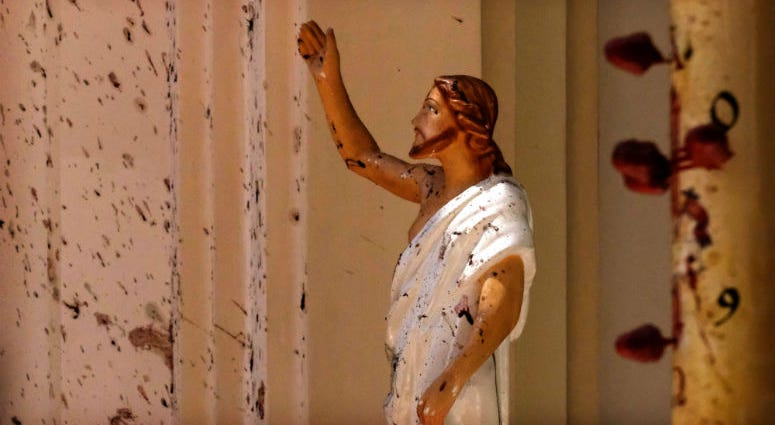 Blood stains are seen on the wall and on a Jesus Christ statue at the St. Sebastian's Church after blast in Negombo, north of Colombo, Sri Lanka, Sunday, April 21, 2019. Blood stains are seen on the wall and on a Jesus Christ statue at the St. Sebastian's Church after blast in Negombo, north of Colombo, Sri Lanka, Sunday, April 21, 2019.